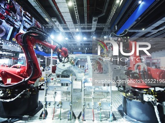 SHANGHAI, CHINA - SEPTEMBER 19, 2023 - Visitors look at Siasun's industrial robot for auto welding at the 23rd China International Industry...
