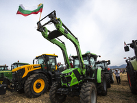 Farmers stand next to their agricultural machinery during a nationwide agricultural protest to save Bulgarian agriculture near the village o...