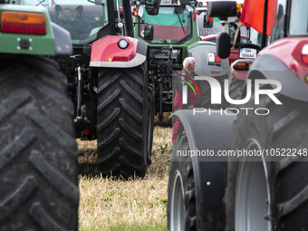 Farmers stand next to their agricultural machinery during a nationwide agricultural protest to save Bulgarian agriculture near the village o...