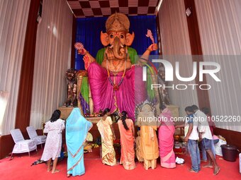 Devotees offer prayers in front of the 30-feet tall idol of Hindu god Ganesha during the 'Ganesh Chaturthi' festival in Guwahati , India on...