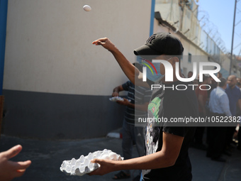 Palestinian protesters throw eggs at the entrance of the Gaza City headquarters of the United Nations Relief and Works Agency for Palestine...
