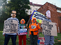 Protestors hold banners during an anti-government protest in Krakow, Poland on September 18, 2023. Protestors organized a rally against the...