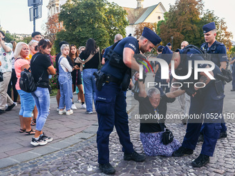 A prominent Polish anti-government activist, Katarzyna Augustynek, known as Babcia Kasia (Grandma Kate), is carried away by police during an...