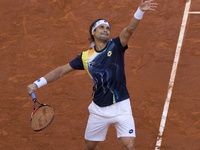 David Ferrer of Spain plays a backhand against Ernests Gulbis of Latvia in their quarter final match during day seven of the Mutua Madrid Op...