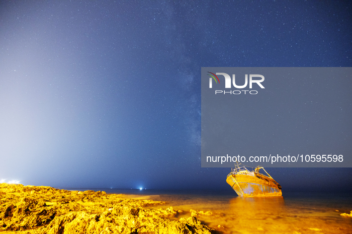 The Milky Way galaxy appears in the sky above the shipwreck of Torre San Giovanni, Puglia, Italy, on October 4, 2023. The fishing vessel dri...
