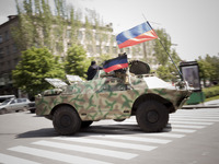 Pro-russian activists from the People's Republic of Donetsk self defence forces drive on an Armored Personnel Carrier in the streets of Done...