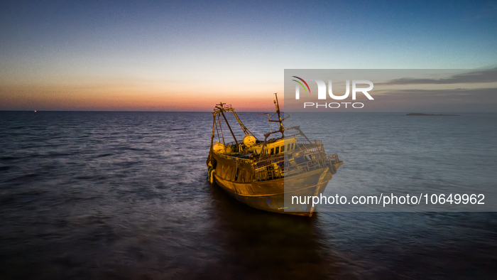 A drone view of the wreck of Torre San Giovanni at sunset, on October 15, 2023. The fishing vessel drifted towards the shores of Torre San G...