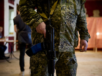 UKRAINE, Slavyansk : An armed man in a polling station prior to vote for the referendum called by pro-Russian rebels in eastern Ukraine to s...