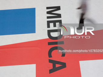 A trade fair attendee is walking past the Medica logo at the Medica Fair 2023 in Dusseldorf, Germany, on November 13, 2023. (