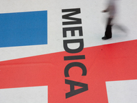 A trade fair attendee is walking past the Medica logo at the Medica Fair 2023 in Dusseldorf, Germany, on November 13, 2023. (