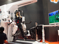 A trade fair attendee is testing a computer-controlled robotic device for walking treatment at the Medica Fair 2023 in Dusseldorf, Germany,...