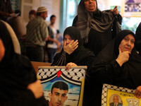 Prisoner's mother crying after prevented from visiting her son in prison Raymond today in front of the Red Cross, in Gaza, on May 12, 2014 i...