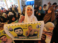 Palestinians take part in a protest demanding the release of their relatives prisoners on hunger strike held in Israeli jails, in front of t...