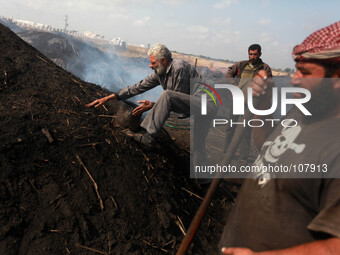 Palestinian workers during the production of charcoal  east of Gaza City east of Jabalya refugee camp , north of Gaza City, on May 12, 2014....