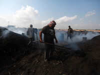 Palestinian workers during the production of charcoal  east of Gaza City east of Jabalya refugee camp , north of Gaza City, on May 12, 2014....