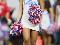 A member of the Detroit Lions cheer squad waits to welcome Lions players to the field ahead of an NFL  football game between the Detroit Lio...
