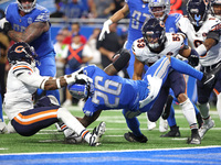 Detroit Lions running back Jahmyr Gibbs (26) is tackled by Chicago Bears safety Eddie Jackson (4) during the second half of an NFL football...