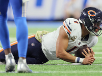Chicago Bears quarterback Justin Fields (1) retains the ball after running for yardage during  an NFL  football game between the Detroit Lio...