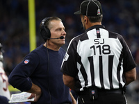 Chicago Bears head coach Matt Eberflus talks to side judge David Meslow during the first half of an NFL football game between the Chicago Be...