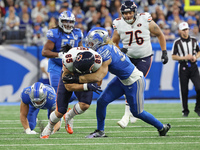 Chicago Bears tight end Cole Kmet (85) ia tackled by Detroit Lions linebacker Alex Anzalone (34) during the first half of an NFL football ga...