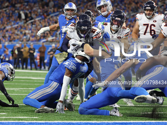 Chicago Bears running back D'Onta Foreman (21) is tackled by Detroit Lions safety Brian Branch (32) during the first half of an NFL football...