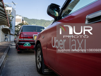 A Taxi with Uber Taxi advertisement on it lining up at a taxi stand on November 21, 2023 in Hong Kong, China. Around 500 Hong Kong Taxis set...