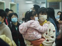 A nurse is preparing an infusion for a child in the infusion area of Hangzhou First People's Hospital in Hangzhou, Zhejiang province, China,...