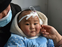 A 7-month-old baby is receiving infusion treatment at the Department of Pediatrics of the People's Hospital in Fuyang, Anhui province, China...