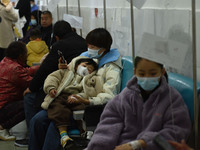 Sick children, accompanied by their parents, are receiving infusion treatment at the Department of Pediatrics of the People's Hospital in Fu...