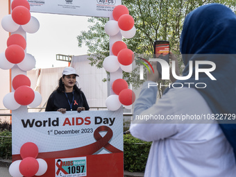 A woman is posing for a photograph in a booth during an event to mark World AIDS Day in Guwahati, Assam, India, on December 1, 2023. (