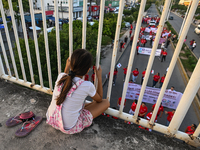 CANCUN, MEXICO - DECEMBER 1, 2023: 
A young girl observes participants of the World AIDS Day March in the center of Cancun, on December 1st,...