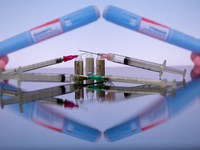 Ozempic by Novo Nordisk is being displayed on a screen alongside pills and a medical vial with a syringe in this photo illustration taken in...