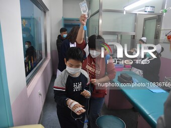 Parents are taking their children for infusion treatment at a hospital in Shenyang, Liaoning province, China, on December 8, 2023. (