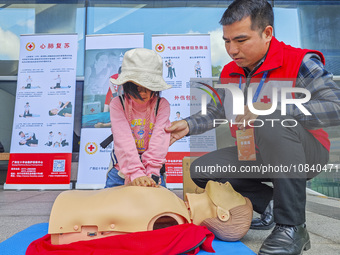 Participants are practicing cardiopulmonary resuscitation (CPR) at the 2023 China-ASEAN Health Industry Summit in Nanning, Guangxi, China, o...