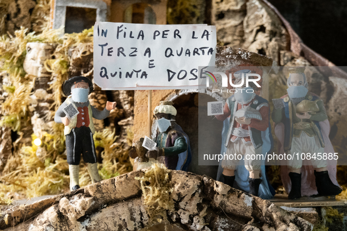 Cribs figurines wearing covid19 masks and holding a banner with a sarcastic message about Covid-19 vaccine is seen in San Gregorio Armeno st...