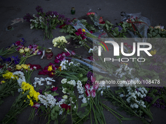 Flowers are displayed on the ground in front of a town hall where Ukrainian national guardsmen opened fire on a crowd outside sunday, killin...