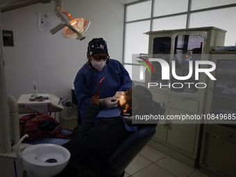 A dentist is performing tests with dental prostheses at the Centro de Odontogeriatria TIII Doctor Guillermo Roman y Carrillo Health Centre i...