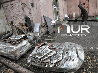 A woman is removing rubble outside a house after a Russian overnight attack in Odesa, southern Ukraine, on December 14, 2023. On the night o...