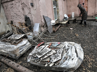 A woman is removing rubble outside a house after a Russian overnight attack in Odesa, southern Ukraine, on December 14, 2023. On the night o...