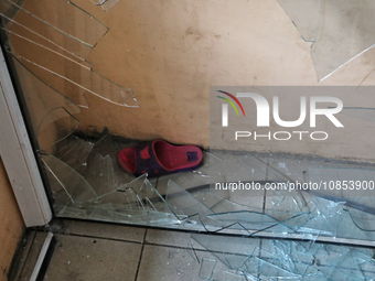 A slipper is seen behind a broken window in a hostel that is being damaged in a Russian overnight attack in Odesa, southern Ukraine, on Dece...