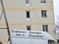 A van bearing the message 'Good evening, we are from Ukraine' is parked outside a hostel that has been damaged in a Russian overnight attack...