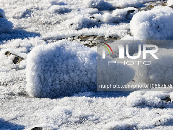 Sea ice and ice skin are wrapping the reef at Liansan Island scenic spot in the West Coast New Area of Qingdao, Shandong Province, China, on...