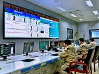 Workers are monitoring heating operations at the main control center of a thermal power company in Nantong, Jiangsu province, China, on Dece...