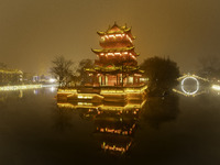 A tower is shrouded in thick smog and polluted air at night in Huai'an, China, on December 28, 2023. (