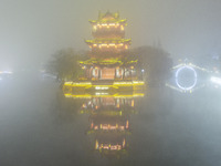 A tower is shrouded in thick smog and polluted air at night in Huai'an, China, on December 28, 2023. (