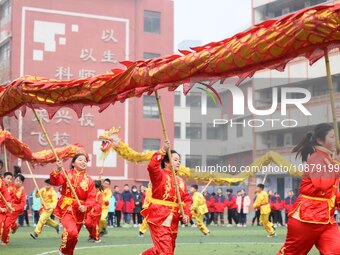 Primary school students are performing a traditional dragon dance in Hefei, Anhui province, China, on December 29, 2023. (