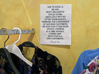 A sign in a clothing store in Toronto, Ontario, Canada, on November 25, 2023, indicates that health officials are announcing that the rate o...