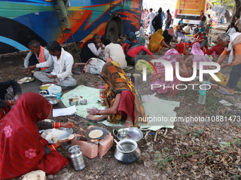 A devotee is arranging food at the Gangasagar transit camp in Kolkata, India, on December 30, 2023. (