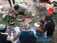 Hindu pilgrims are being served a meal at a transit camp in Kolkata, India, on December 30, 2023, as they return from Gangasagar. (