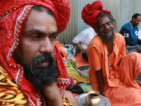 Sadhus and pilgrims are arriving at the Gangasagar Mela transit camp on their way to the annual Hindu festival at Gangasagar, where they wil...